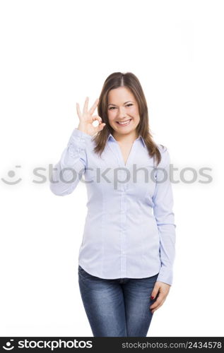 Beautiful woman smiling and doing a ok signal with her hand, isolated over a white background