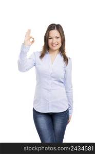 Beautiful woman smiling and doing a ok signal with her hand, isolated over a white background