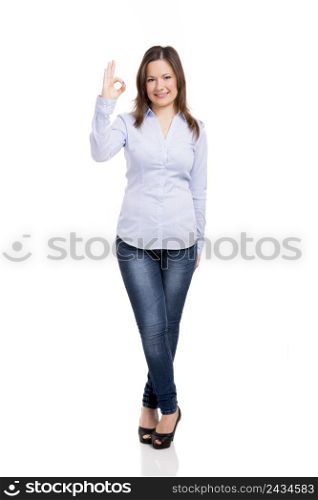 Beautiful woman smiling and doing a ok signal with her hand, isolated over a white background