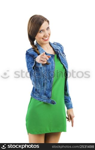 Beautiful woman smiling and pointing to you, isolated over a white background
