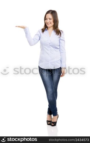 Beautiful woman smiling and showing the palm of her right hand, isolated over a white background