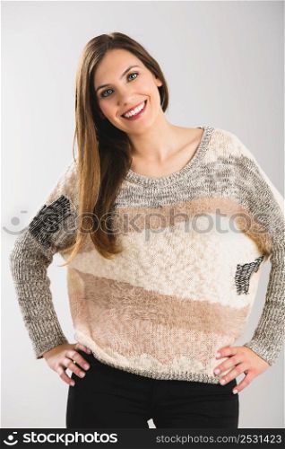 Beautiful woman smiling, isolated over a grey background