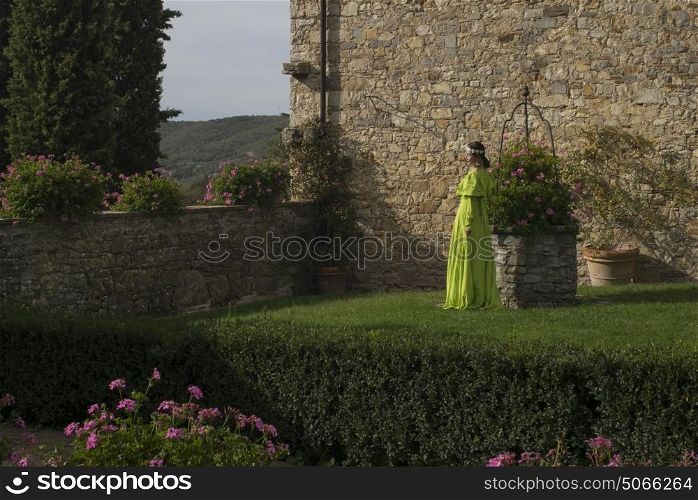 Beautiful woman standing in yard, Gaiole in Chianti, Tuscany, Italy