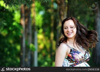 beautiful woman standing near tree. summer&acute;s day.