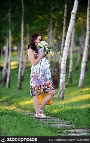 beautiful woman standing near tree. summer&acute;s day.
