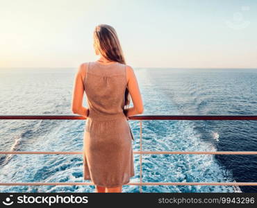 Beautiful woman standing on the deck of a cruise ship. Close-up. Vacation and travel concept. Beautiful woman standing on the deck of a cruise ship