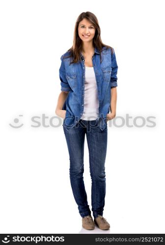 Beautiful woman standing over a white background with hands on the pockets and smiling. Beautiful woman