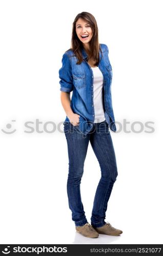 Beautiful woman standing over a white background with hands on the pockets and smiling. Beautiful woman