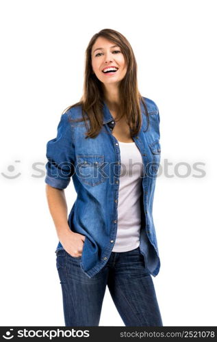 Beautiful woman standing over a white background with hands on the pockets and smiling. Beautiful woman