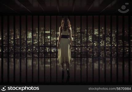 Beautiful woman staring at night city