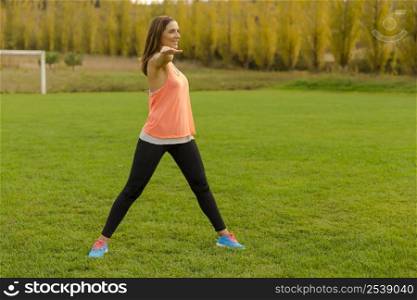 Beautiful woman stretching her muscles after finish the workout