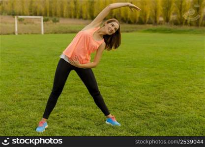 Beautiful woman stretching her muscles after finish the workout