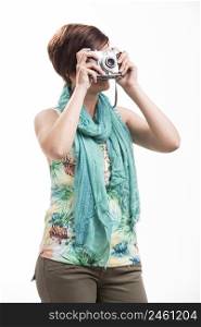 Beautiful woman taking a photo with a vintage camera, isolated over white background
