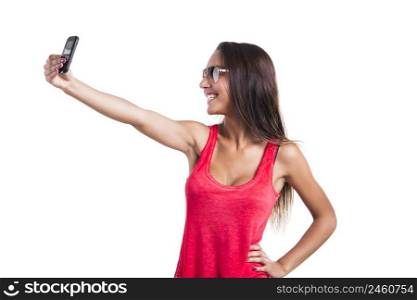 Beautiful woman taking a selfie with her cellphone, isolated over white background