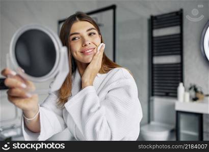 beautiful woman taking care her face