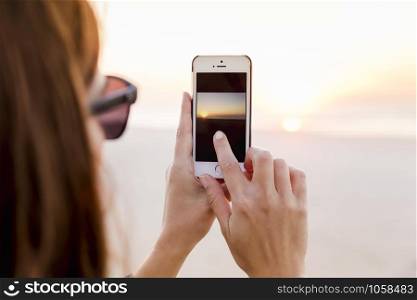 Beautiful woman taking pictures with a cellphone