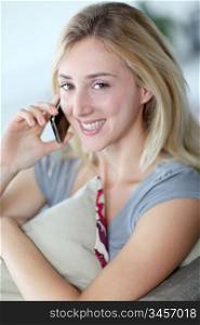 Beautiful woman talking on mobilephone at home