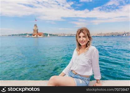 Beautiful woman traveler is in front of Maiden Tower,a popular destination in Istanbul,Turkey. Beautiful woman traveler is in front of Maiden Tower,a popular destination in Istanbul,Turkey