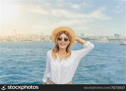 Beautiful woman traveler stands in front of Bosphorus,a popular destination in Istanbul,Turkey. Beautiful woman traveler stands in front of Bosphorus,a popular destination in Istanbul,Turkey