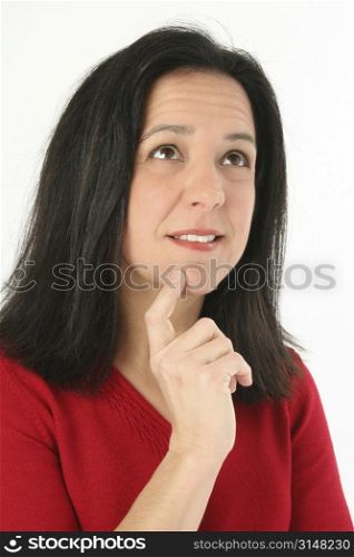 Beautiful woman trying to make a decision, looking up. Wearing red sweater, shot over white in studio.