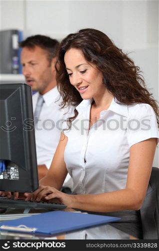 Beautiful woman typing on computer desk