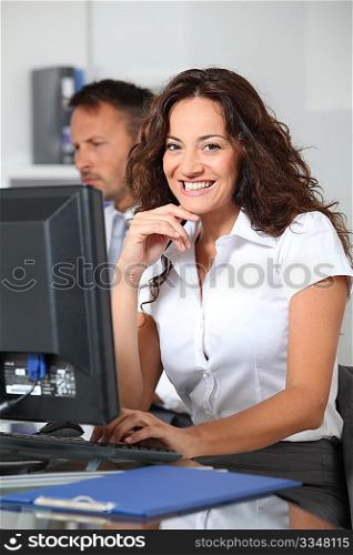 Beautiful woman typing on computer desk