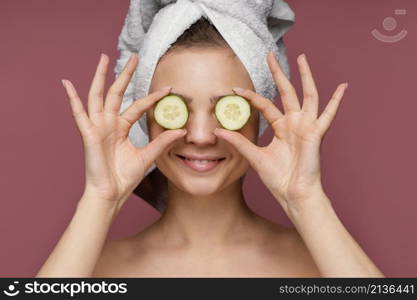beautiful woman using cucumber slices eyes