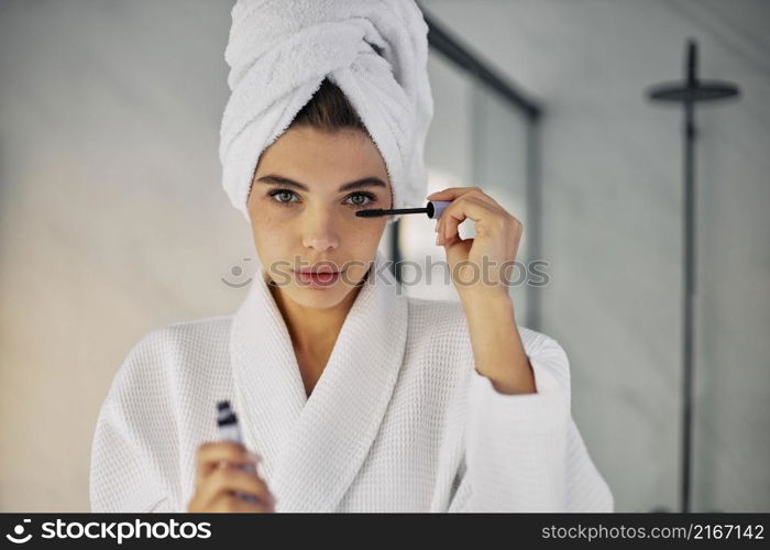 beautiful woman using mascara