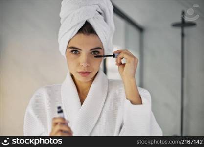 beautiful woman using mascara