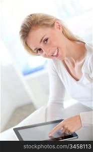 Beautiful woman using tablet at home