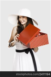 Beautiful woman very happy with the surprise inside of the red box