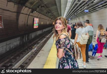 Beautiful woman waits Marmaray train in subway metro,Istanbul,Turkey.. Beautiful woman travels with ferry between Asia and Europe