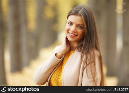 Beautiful woman walking at alley in autumn park