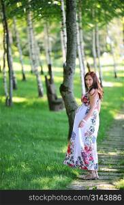 beautiful woman walking in grove birch. summer&acute;s day.