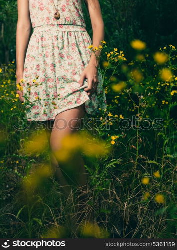 Beautiful woman walks at the country. Casual dress, barefoot.