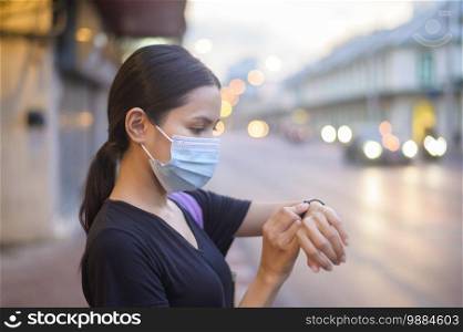 Beautiful woman wearing a surgical mask outdoor, covid-19 , health and pollution concept. 