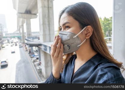 Beautiful woman wearing anti dust mask protect air pollution and pm 2.5 on street city