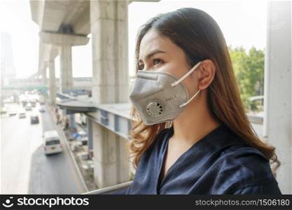 Beautiful woman wearing anti dust mask protect air pollution and pm 2.5 on street city