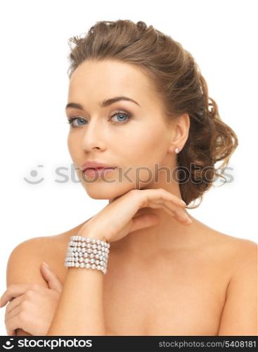 beautiful woman wearing pearl earrings and bracelet