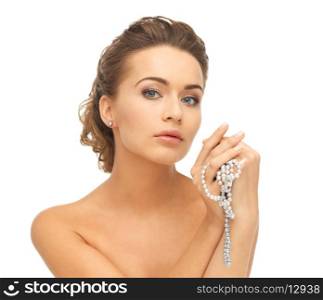beautiful woman wearing pearl earrings and necklace