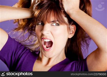 Beautiful woman with a angry expression pulling her hair