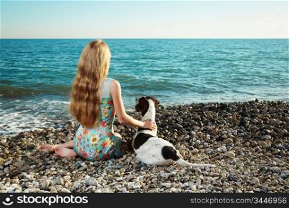 Beautiful woman with a dog on the beach