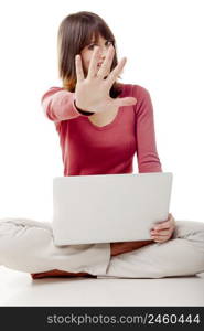 Beautiful woman with a laptop, sitting on the floor with one hand in front of the face