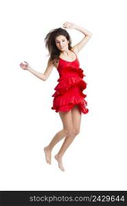 Beautiful woman with a red dress dancing and jumping, isolated on white