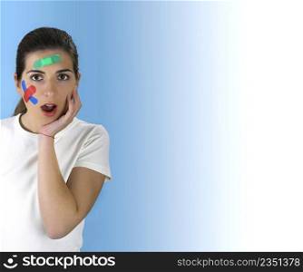 Beautiful woman with a surprised face beacuse of th over a blue background