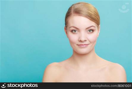 Beautiful woman with bare shoulders. Beautiful woman with bare shoulders. Attractive girl with perfect clean skin. Studio shon on blue green background