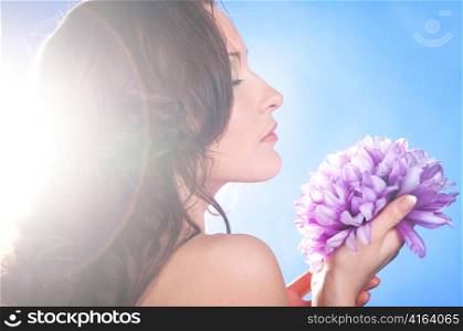 beautiful woman with big flower on blue background