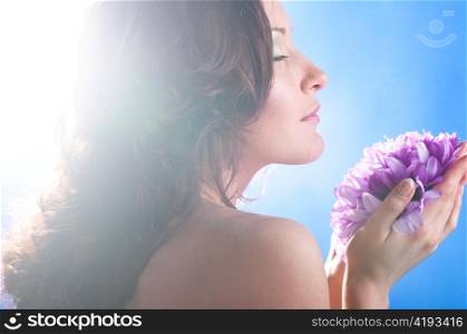 beautiful woman with big flower on blue background