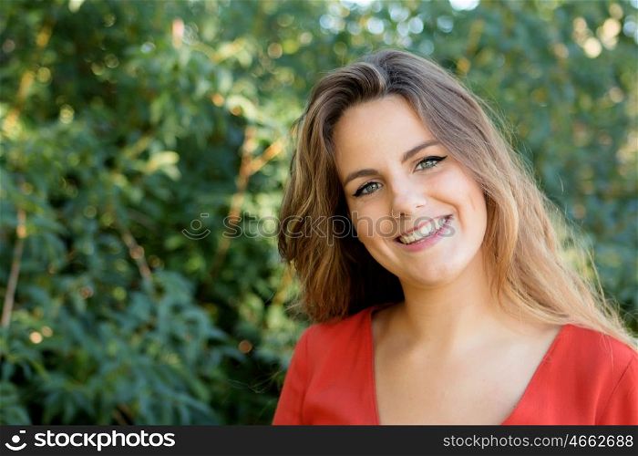 Beautiful woman with blue eyes dressed in red on a sunny day outside