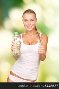 beautiful woman with bottle of water over green